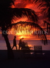ANTIGUA, sunset with coconut trees and holidaymakers in silhouette, ANT728JPL