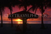 ANTIGUA, sunset with coconut trees and sunshade in silhouette, ANT815JPL