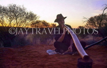 AUSTRALIA, Northern Territory, Digeridoo player, dusk, near Ayers Rock (Uluru), AUS231JPLA