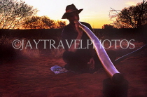 AUSTRALIA, Northern Territory, Digeridoo player, dusk, near Ayers Rock (Uluru), AUS375JPL