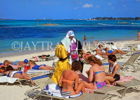 BAHAMAS, New Providence Island, Cable Beach, sunbathers, souvenir seller, BAH373JPL
