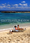 BAHAMAS, Paradise Island, beach, sunbathing couple and child, BAH352JPL