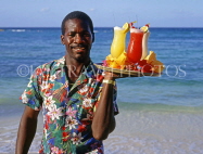 BAHAMAS, Paradise Island, waiter on beach with cocktails on tray, BAH394JPL