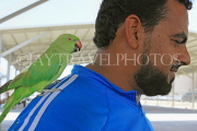 BAHRAIN, Isa Town Market (souk), flea market, bird market, man with parrot, BHR463JPL