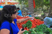 BAHRAIN, Noor El Ain, Garden Bazaar, Farmers Market, shopper at vegetable stall, BHR1248JPL