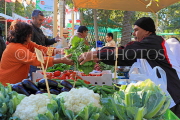 BAHRAIN, Noor El Ain, Garden Bazaar, Farmers Market, shopper at vegetable stall, BHR1783JPL