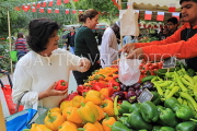 BAHRAIN, Noor El Ain, Garden Bazaar, Farmers Market, stalls, peppers, and shopper, BHR2025JPL