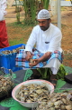 BAHRAIN, Noor El Ain, Grand Bazaar, Farmers Market, man opening oysters, BHR2086JPL