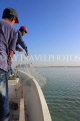 BAHRAIN, coast by Al Jasra, fishermen in boat pulling in net, BHR1403JPL