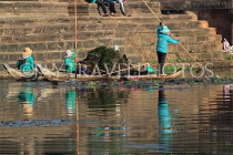 CAMBODIA, Siem Reap, Angkor Wat, moat cleaners in boat, CAM556JPL