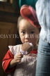 CHINA, Guangxi Province, Guilin, Longji, Ping An, Red Yao tribe girl with ice cream, CH1660JPL