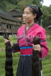 CHINA, Guangxi Province, Guilin, Red Yao woman holidng braids of hair (to add to her mane), CH1532JPL