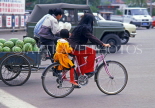CHINA, Hebei Province, Chengde, cyclist with child on back seat, and tricycle transporting melons, CH1409JPL