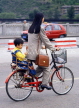 CHINA, Hebei Province, Chengde, woman and child riding bicycle, CH136JPL