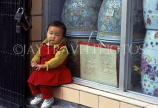 CHINA, Shanghai, young child seated at window ledge, CH138JPL