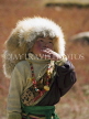 CHINA, Sichuan Province, Daocheng, A Tibetan girl in fur hat whistling, CH1594JPL