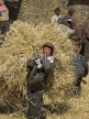 CHINA, Sichuan Province, Daocheng, Tibetan carrying barley straw, CH1498JPL