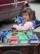 CHINA, Yunnan Province, Dali, Dali, girl seated on mothers thermos cart, CH1649JPL