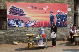 CHINA, Yunnan Province, Jianshu, government propaganda mural and street vendors, CH1607JPL