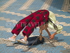 CHINA, Yunnan Province, Lijiang, street entertainer, girl performing acrobat, CH1653JPL