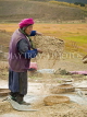 CHINA, Yunnan Province, Shangri La, Tibetan farmer sifting barley, CH1572JPL