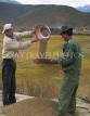 CHINA, Yunnan Province, Shangri La, two Tibetan men working the barley, CH1516JPL