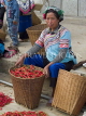 CHINA, Yunnan Province, Yuanyang, Hani tribe vendor with basket of chillies, Shalatou market, CH1545JPL
