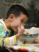 CHINA, Yunnan Province, Yuanyang, boy eating noodles, CH1665JPL