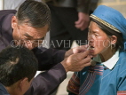 CHINA, Yunnan Province, Yuanyang, dentist attending to Hani woman, CH1667JPL