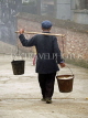 CHINA, Yunnan Province, Yuanyang market, Hani man carrying water, CH1591JPL