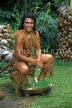 COOK ISLANDS, Rarotonga, Cultural Village, Maori man demonstrating coconut scraping, CI168JPL