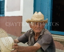 CUBA, Trinidad, old town street, elderly man selling straw hats, CUB364JPL