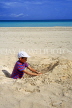 CUBA, Varadero, beach, boy (tourist) making sandcastle, CUB249JPL