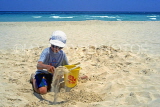 CUBA, Varadero, beach, boy (tourist) playing with bucket and spade, CUB312JPL