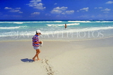 CUBA, Varadero, beach, boy (tourist) walking along, CUB247JPL