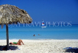 CUBA, Varadero, beach, thatched sunshade and sunbather, CUB119JPL
