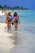 CUBA, Varadero, beach, two women (holidaymakers) walikng along, CUB234JPL