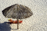 CUBA, Varadero, sunbather under thatched sunshade, CUB786JPL