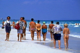 CUBA, Varadero, tourists walking along beach, CUB161JPL