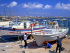 CYPRUS, Paphos, Kato Paphos, boatyard, men painting fishing boat, CYP225JPL