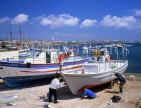 CYPRUS, Paphos, Kato Paphos, harbourfront boatyard, men painting boat, CYP226JPL
