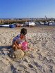 Channel Islands, JERSEY, boy playing on beach, building sand castle, UK10378JPL