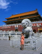 China, BEIJING, Tiananmen Gate (Forbidden City), woman posing by lion sculpure, CH1105JPL