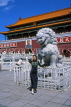 China, BEIJING, Tiananmen Gate (Forbidden City), woman tourist posing by lion sculpure, CH1180JPL