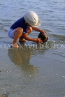 DOMINICAN REPUBLIC, North Coast, Playa Dorada, boy (tourist) playing with coconut, DR232JPL