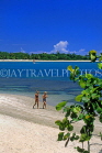 DOMINICAN REPUBLIC, North Coast, Playa Dorada, couple of tourists walking on beach, DR340JPL