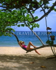 DOMINICAN REPUBLIC, North Coast, Playa Dorada, tourist relaxing on tree branch, DR208JPL
