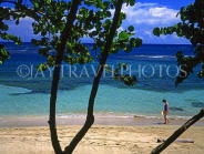 DOMINICAN REPUBLIC, North Coast, Playa Dorada, tourist walking along beach, DR258JPL