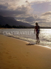 DOMINICAN REPUBLIC, North Coast, Playa Dorada, tourist walking along beach at sunset, DR335JPL