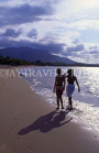 DOMINICAN REPUBLIC, North Coast, Playa Dorada, two tourists walking along beach, DR107JPL